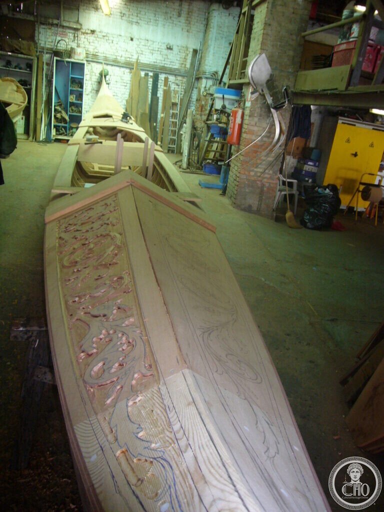 Stern deck of a gondola under construction with foliage ornament partly carved and partly drawn