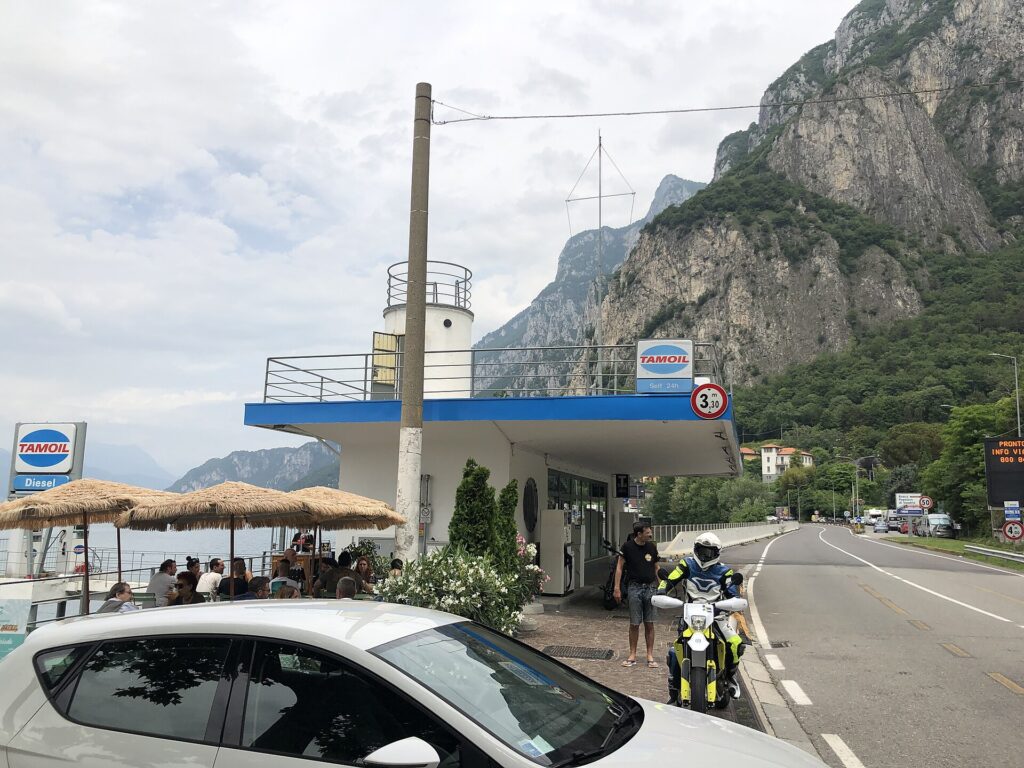 The lakeside service station at Lecco by Mario Cereghini, a deck-like canopy with railings and a small cylindrical tower