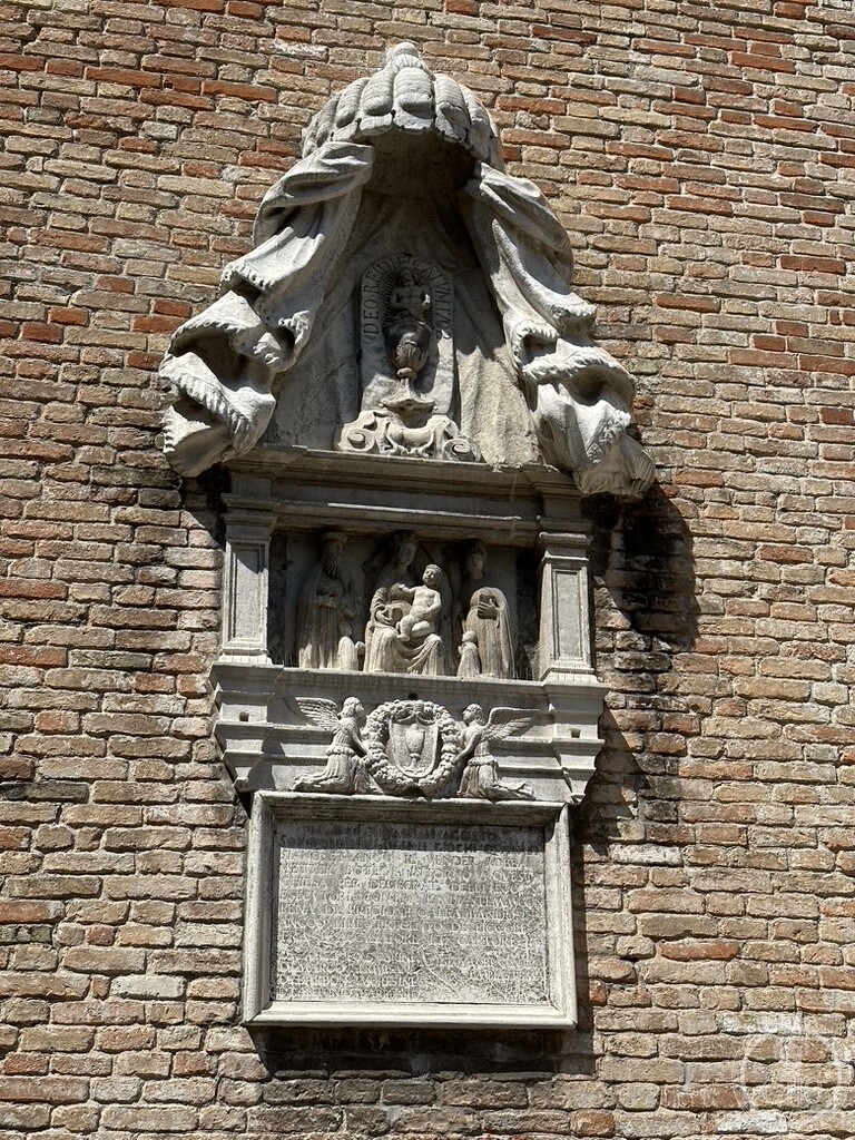 Carved marble tabernacle relief and 1611 magistrate decree against blasphemy set into the brick wall of the Church of San Polo in Venice