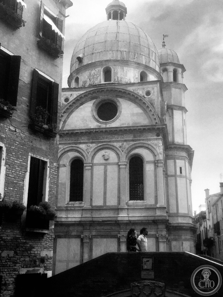 Dramatic black and white perspective of the Renaissance marble dome and semicircular apse of Santa Maria dei Miracoli and Ponte dei Miracoli in Venice
