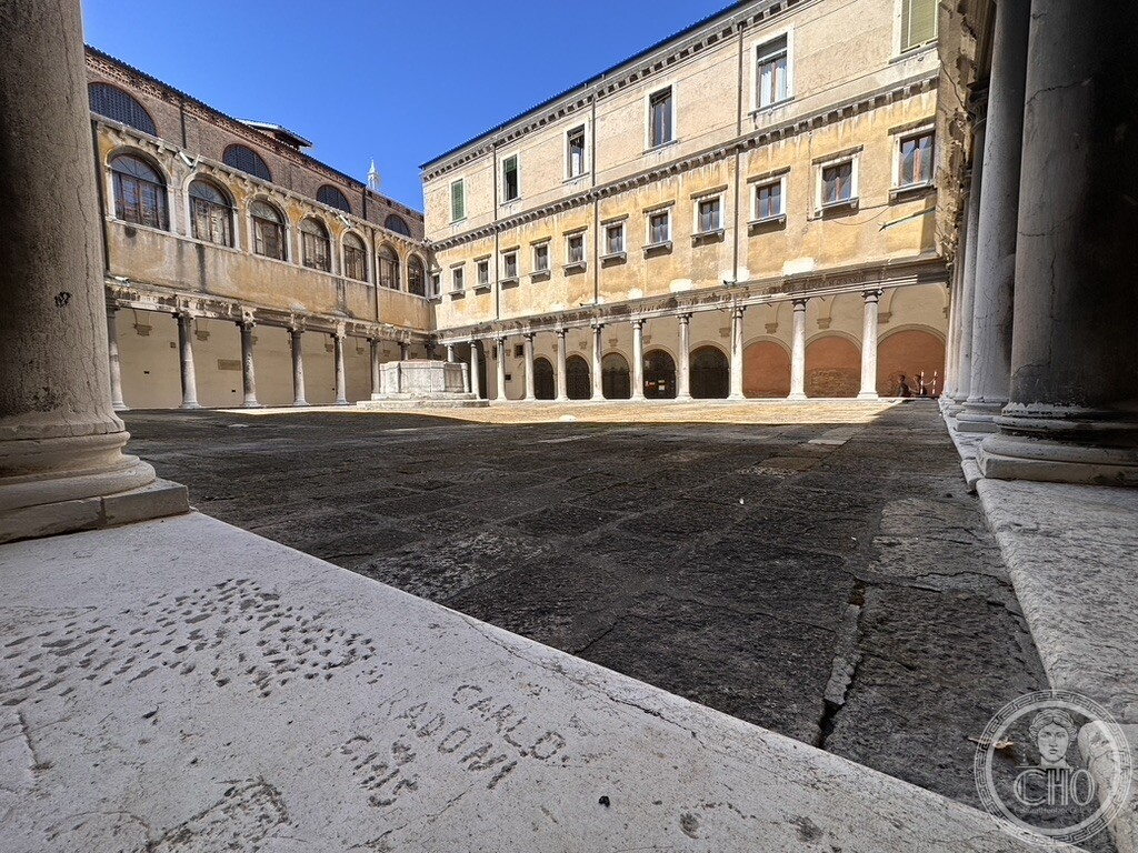 Arcaded cloister courtyard with a stone wellhead, part of the former Franciscan convent of the Frari, now the Archivio di Stato di Venezia