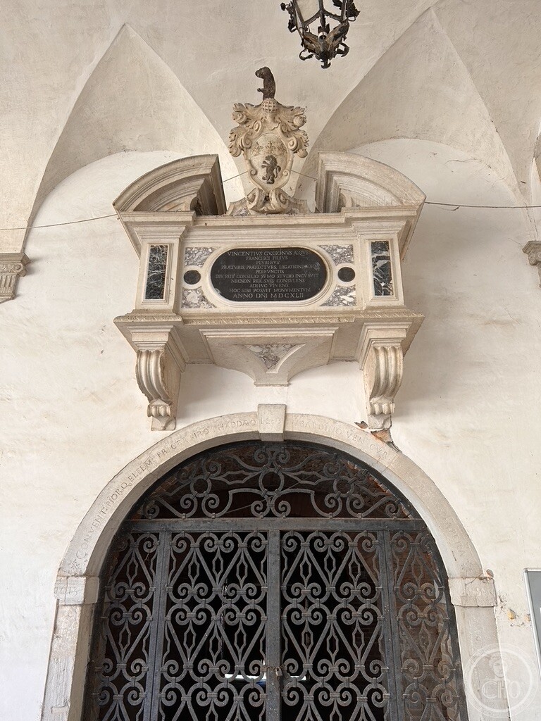 Seventeenth-century marble funerary monument of knight Vincenzo Gussoni above a wrought-iron gate in the Cloister of Santo Stefano in Venice