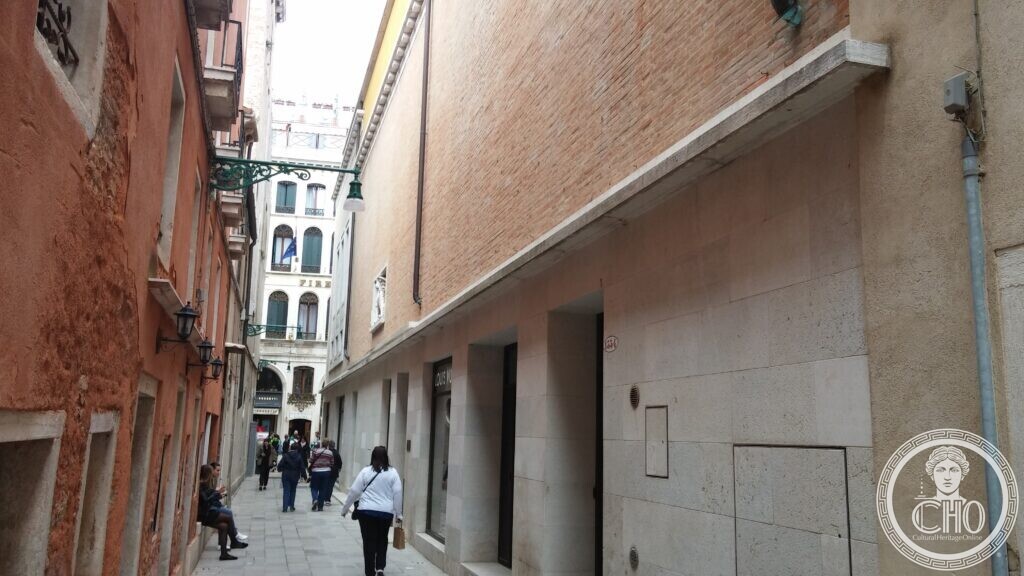 Stone facade of the former Cinema Teatro San Marco building seen along the narrow calle, Venice
