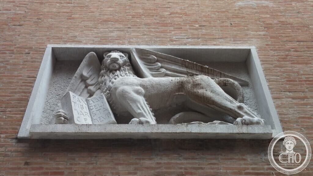 Vertical stone relief panel carved with doves in flight by Napoleone Martinuzzi, on the facade of the former Cinema Teatro San Marco, Venice