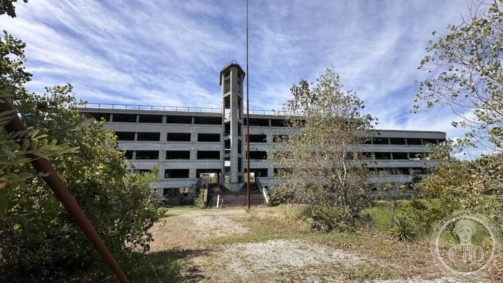 The Colonia Novarese at the end of a gravel drive, the stair tower on the central axis