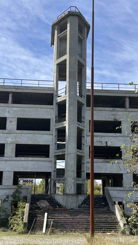 The open concrete stair tower of the Colonia Novarese seen from directly below