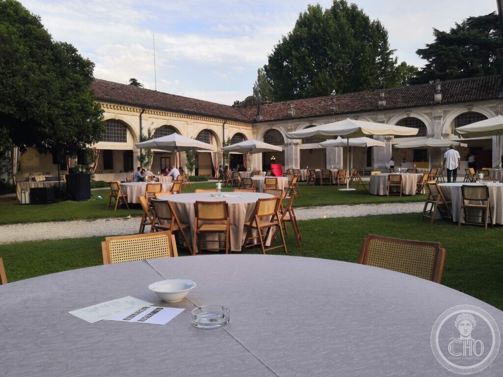 The arcaded courtyard of Villa Condulmer set with tables and white umbrellas