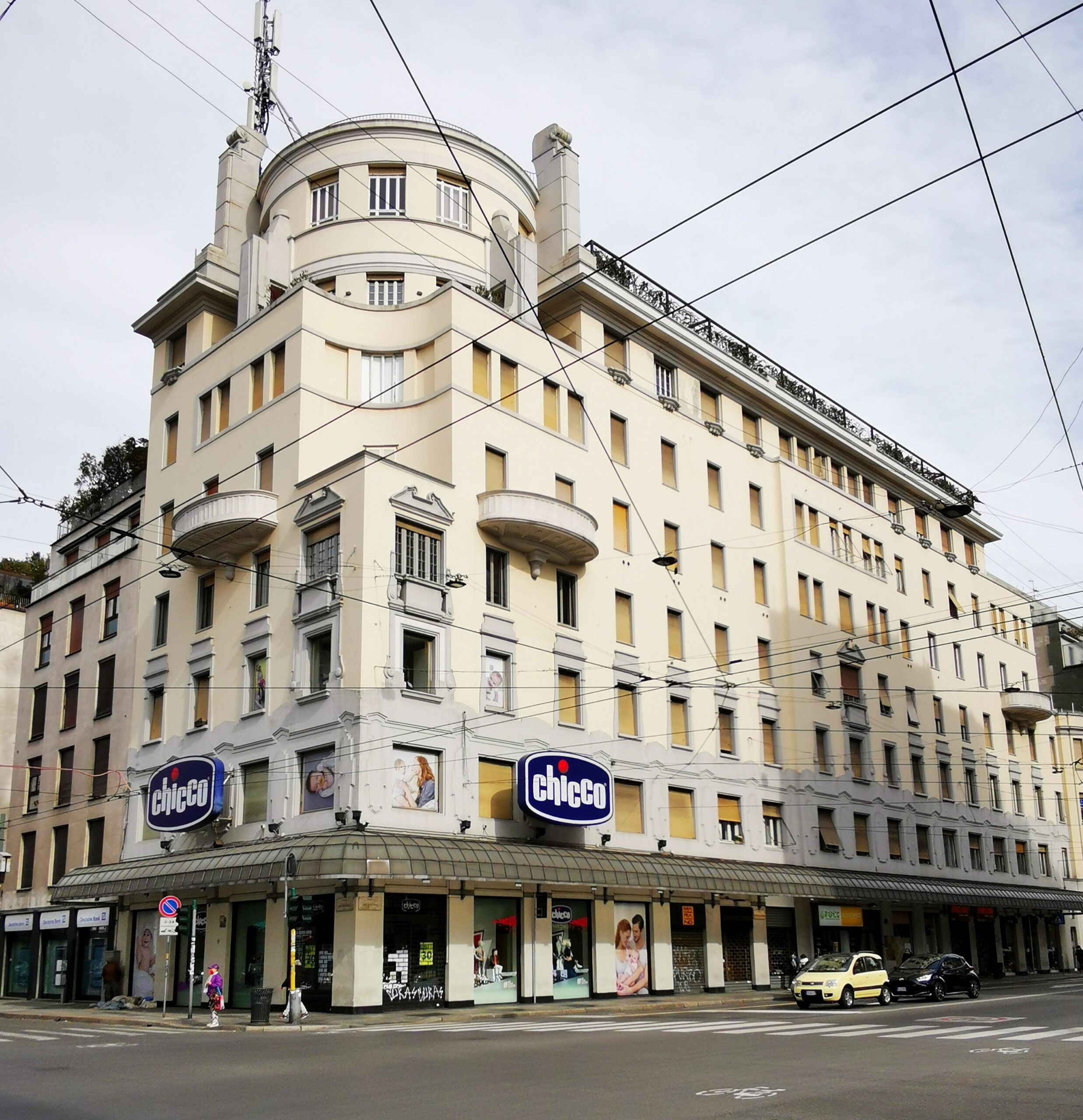 Historic commercial architecture on Corso Buenos Aires in Milan with pedestrian sidewalks