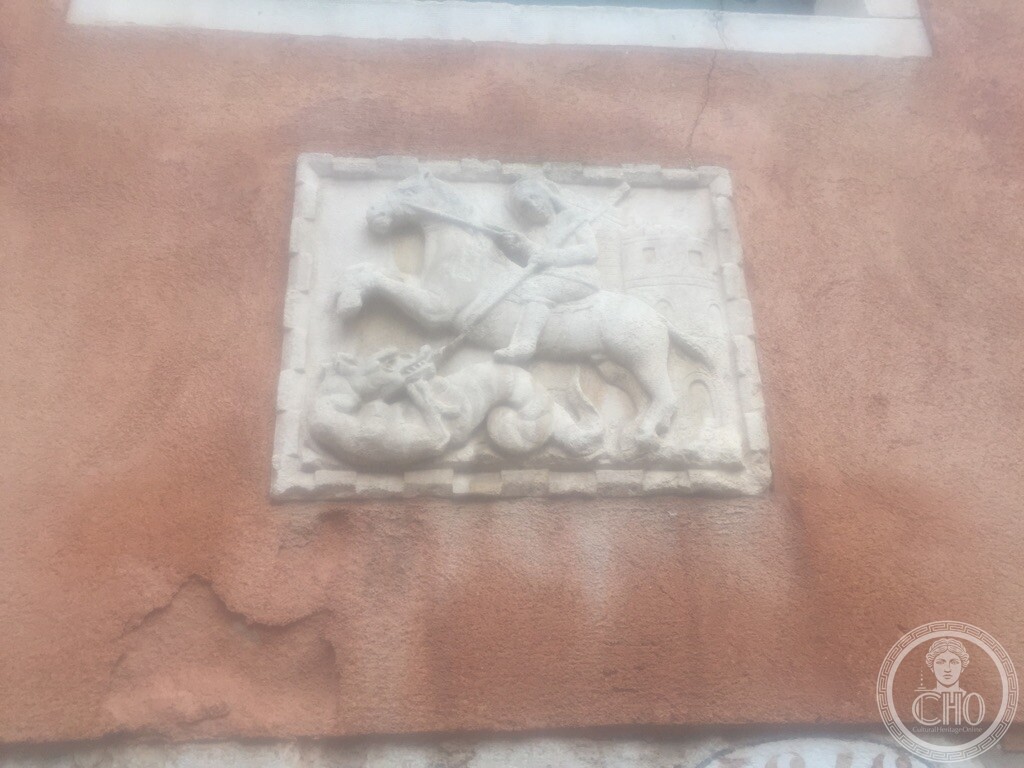 Renaissance Istrian stone relief depicting Saint George slaying the dragon mounted on the facade at Corte Bollani, Venice