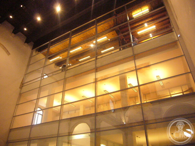 Lit glass-walled floors of the workshop spaces inserted into the former church