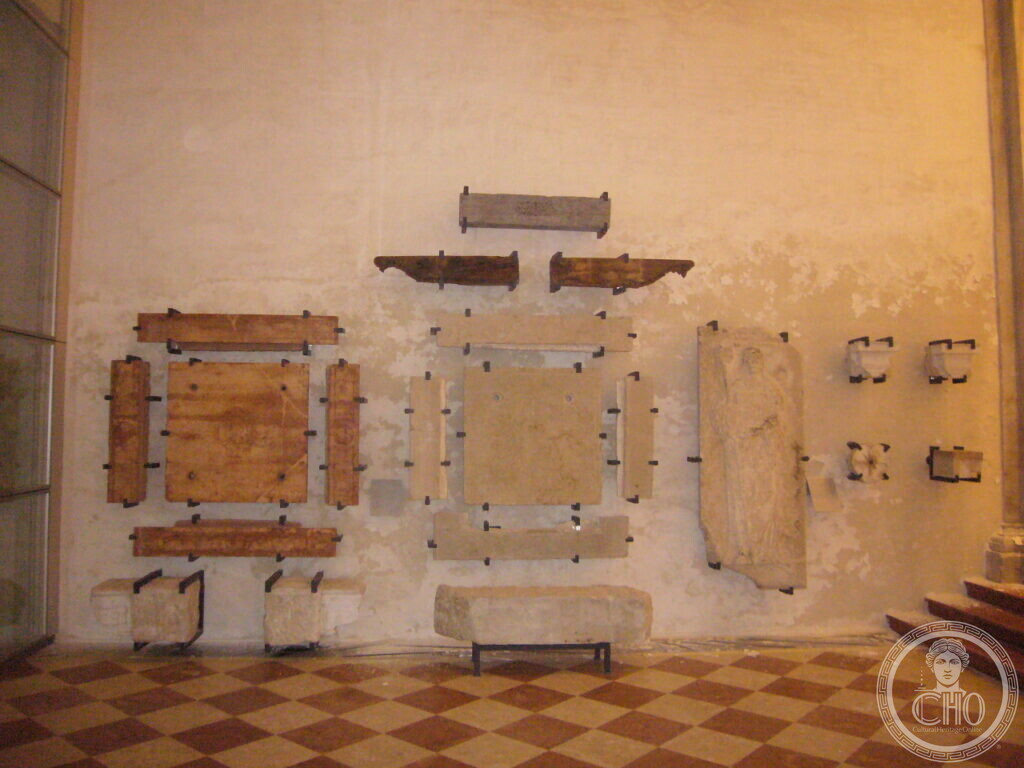 Stone fragments and inscriptions mounted on the restored wall of the former church