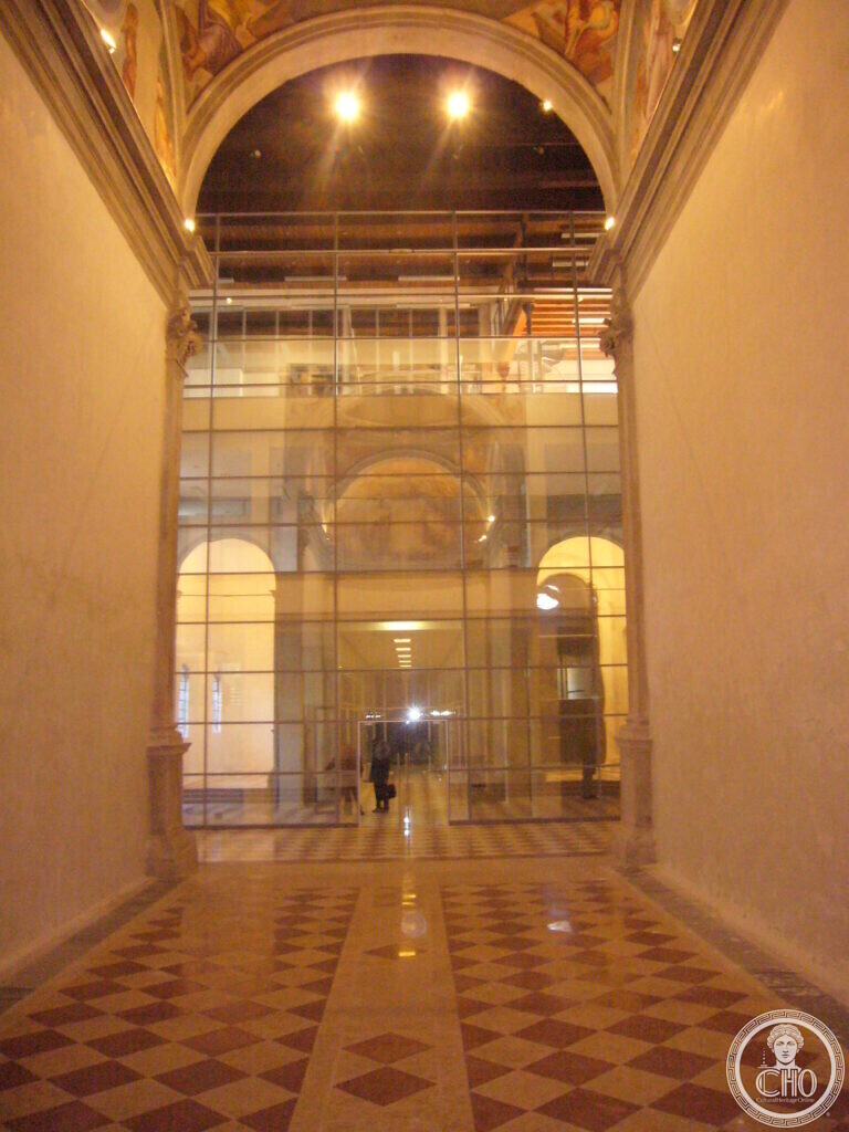 Restored nave of the former church with chequered marble floor and glass partition
