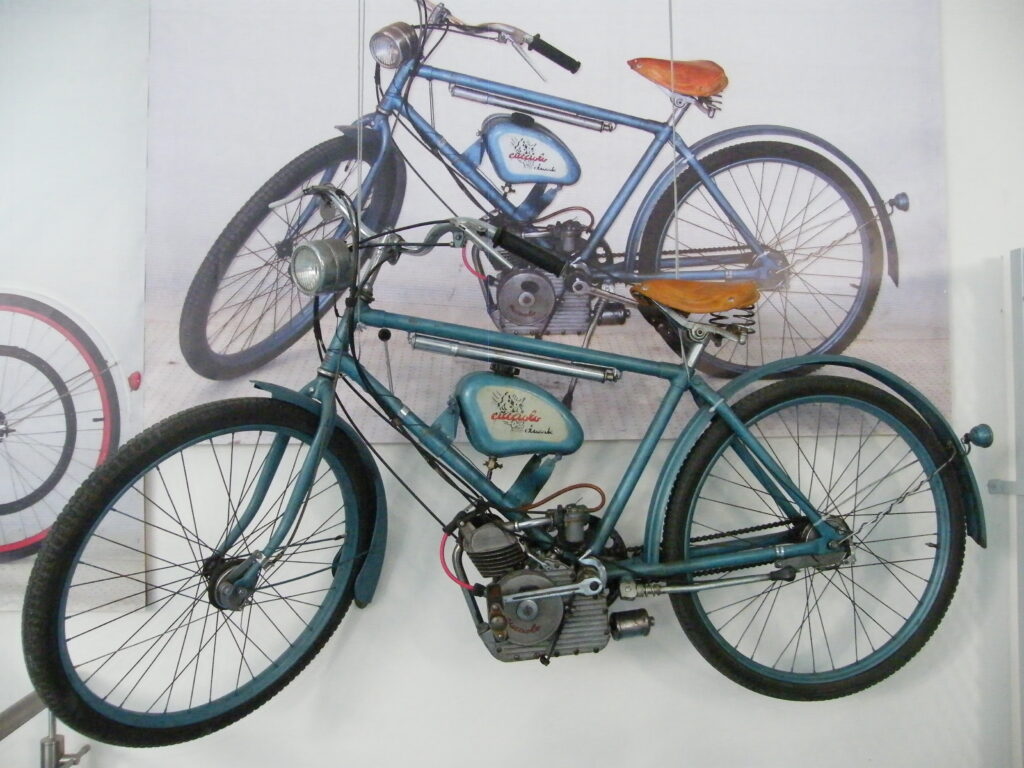 The vintage 1948 Ducati Cucciolo auxiliary engine mounted on a black bicycle frame
