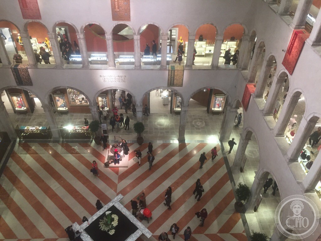 The Fondaco dei Tedeschi's arcaded inner courtyard with its striped marble floor, seen from an upper gallery