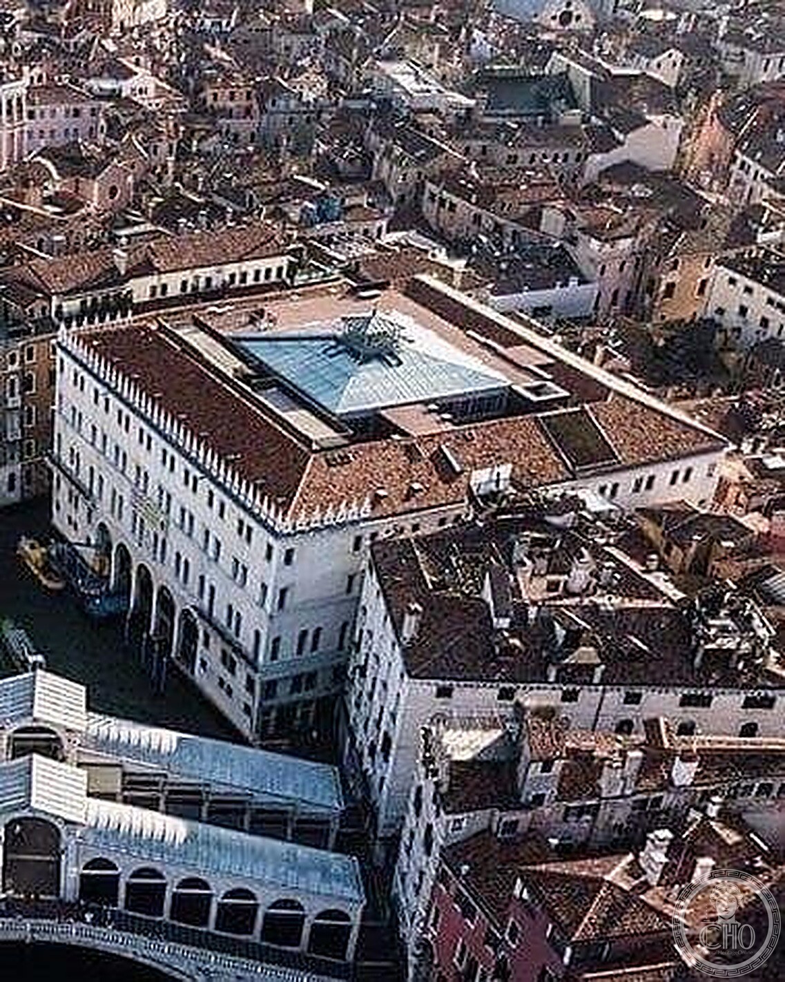 Aerial view of the Fondaco dei Tedeschi and its diamond glass roof beside the Rialto Bridge, still frame from a drone video