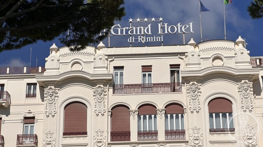The main facade of the Grand Hotel with the roof sign and rows of arched windows
