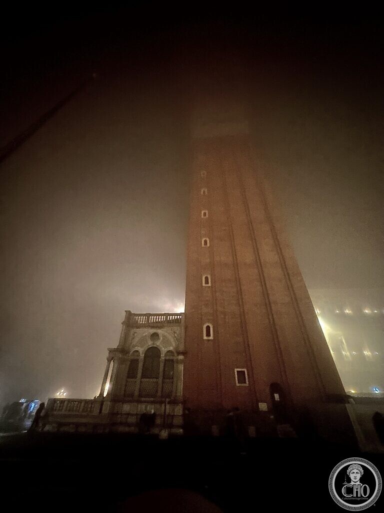 St Mark's Campanile disappearing into fog at night, the Loggetta at its foot