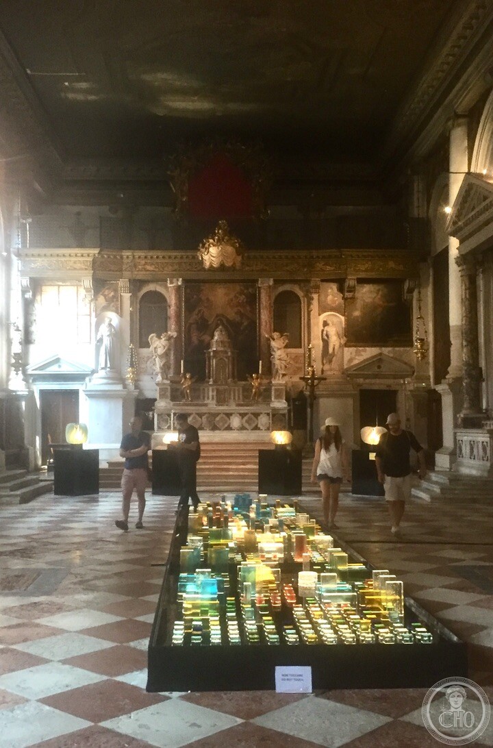 The interior of the Ospedaletto church in Venice with a contemporary Murano glass installation on the checkerboard floor