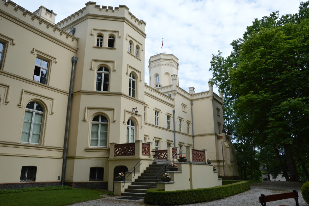 Mierzecin Palace in western Poland, an English neo-Gothic house with a tower, seen from the lawn