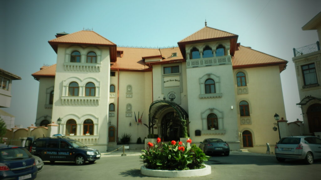 Palatul Suter on Filaret Hill, Bucharest: a cream villa with two towers under terracotta pyramid roofs, arched windows and an iron canopy over the entrance