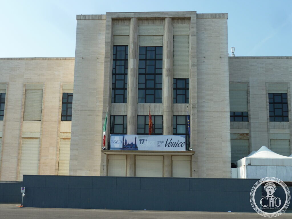 Close view of the central portal of the Palazzo del Casino, with its four fluted travertine pilasters and tall windows