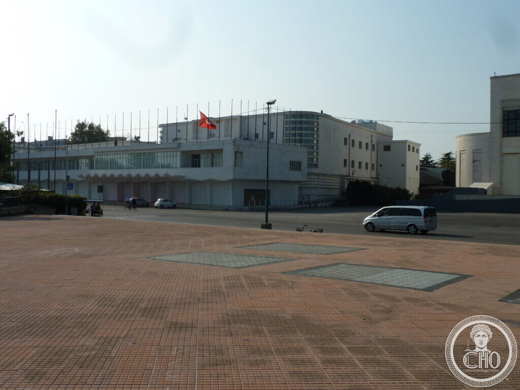 The white modernist facade of the Palazzo del Cinema on the Lido di Venezia, with its rooftop flagpoles