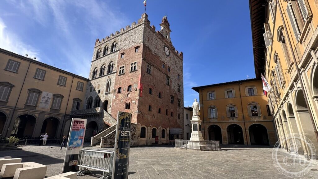The external staircase of the Palazzo Pretorio rising to the first floor above a stone arcade