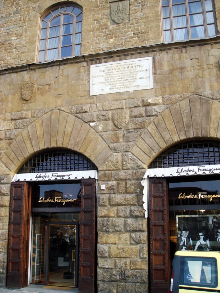 Historic gothic stone portal and arched entrance of Palazzo Spini Feroni along Via Tornabuoni