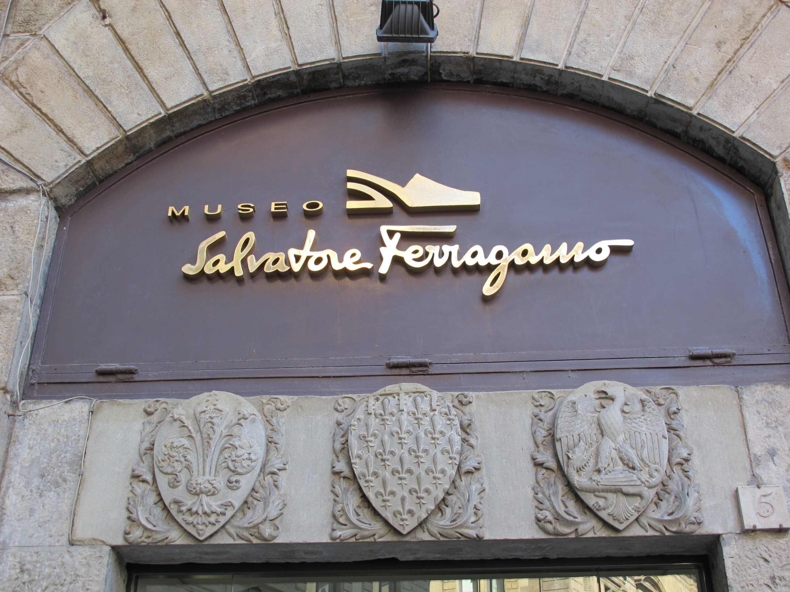 The 13th-century stone crenellated fortress facade of Palazzo Spini Feroni in Florence
