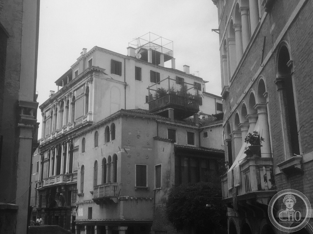 View from Ponte de la Panada showing the Baroque facade of Palazzo Widmann by Baldassarre Longhena and traditional wooden altane roof terraces