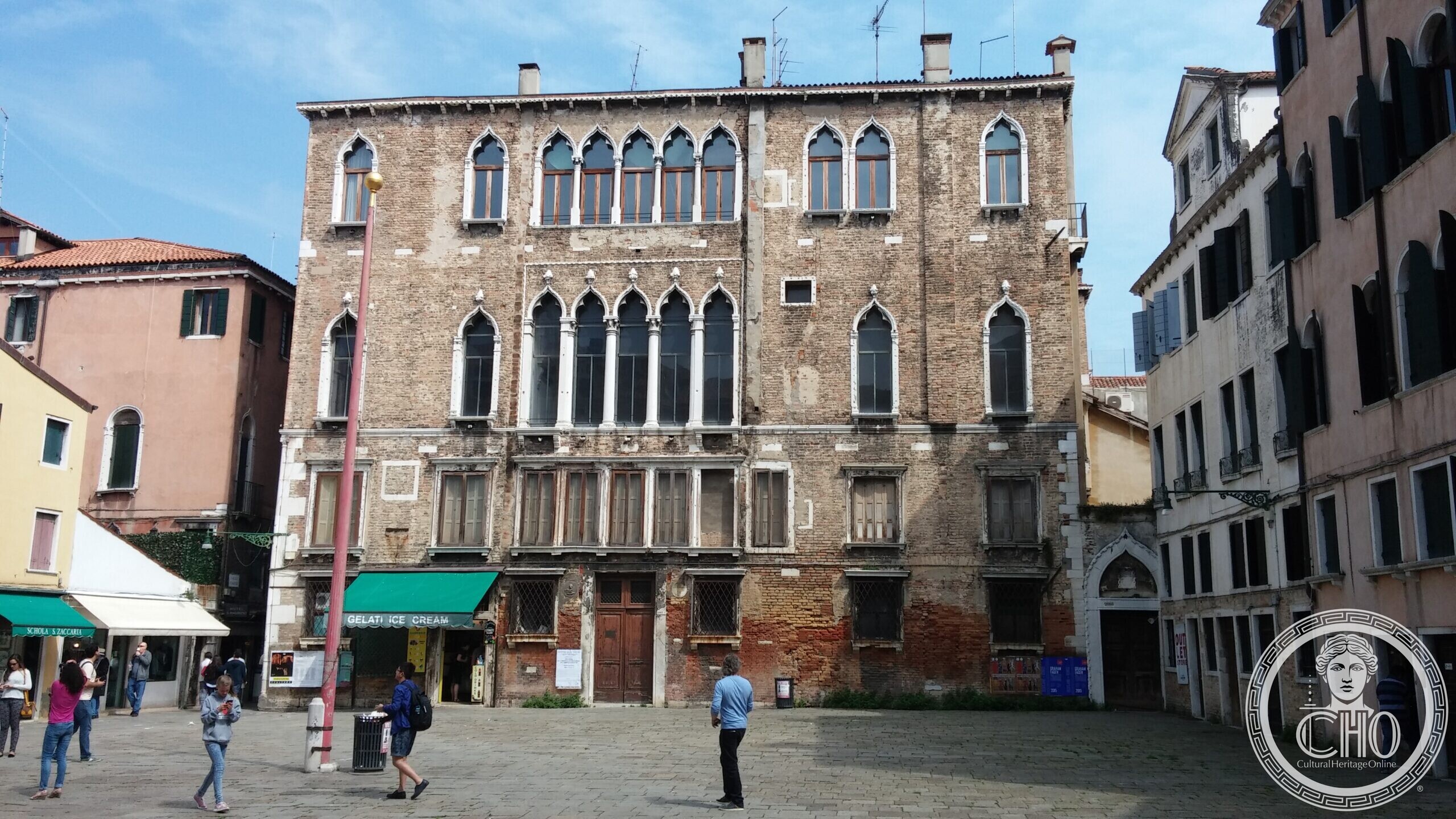 The ground floor of Palazzo Zaguri in Venice, with its wooden door, barred windows and a carved portrait medallion
