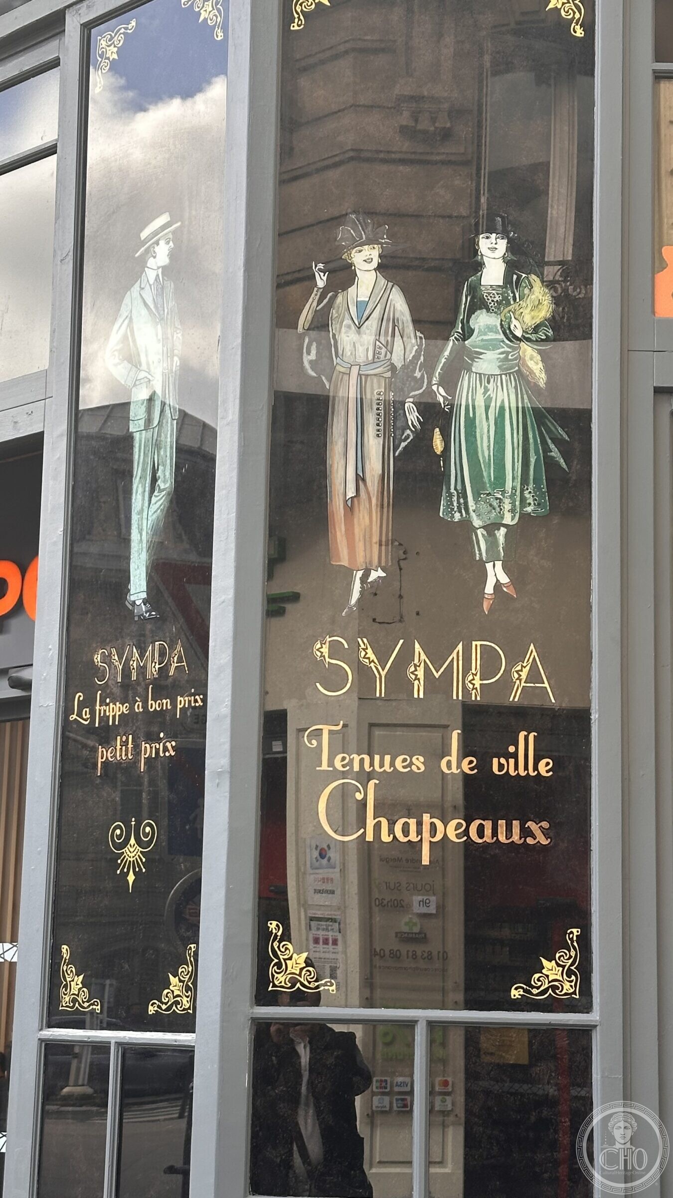 Painted shop windows with 1920s figures and the lettering SYMPA, Tenues de ville, Chapeaux