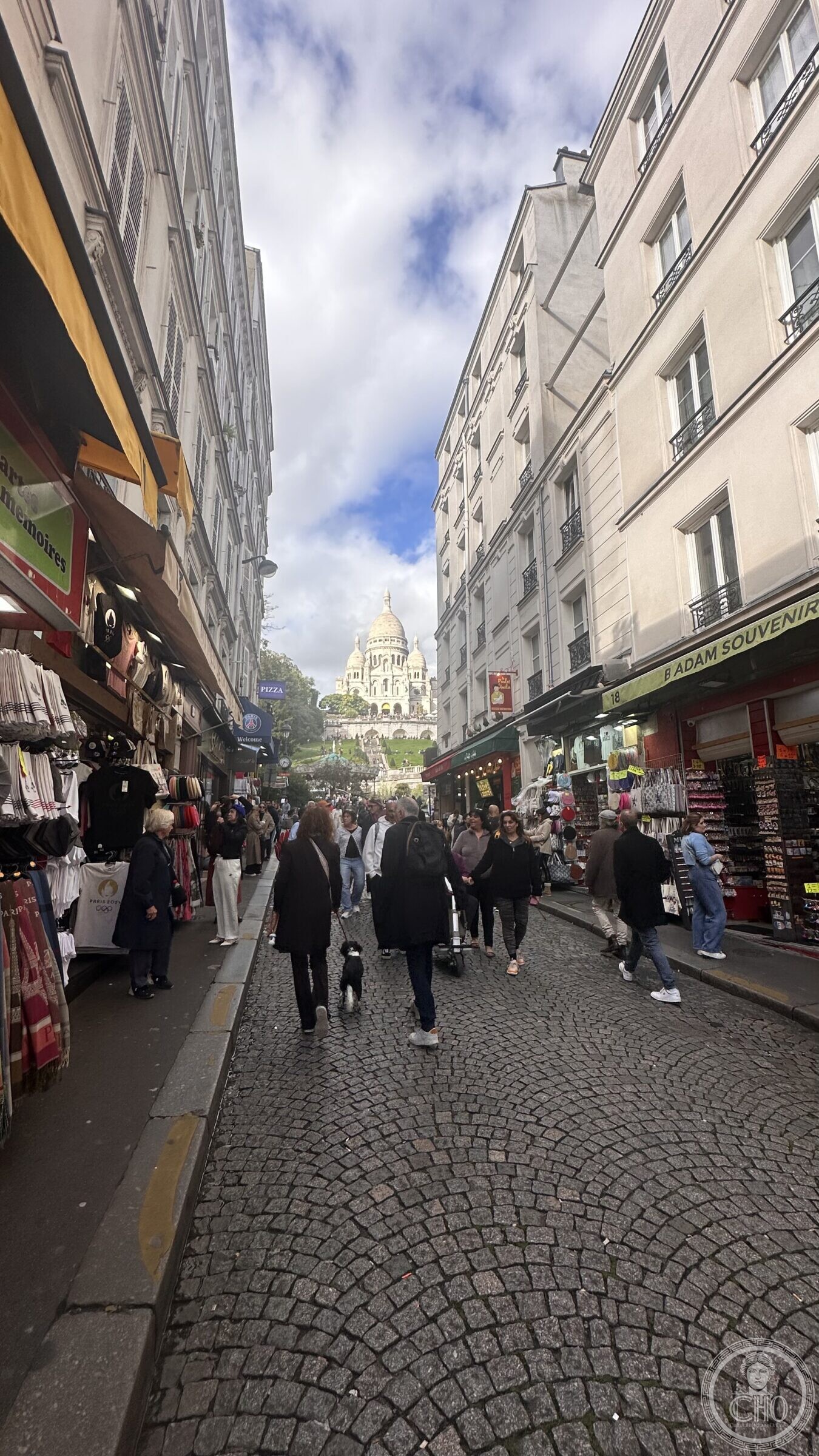 Rue de Steinkerque looking up to the dome of Sacré-Cœur between souvenir shops