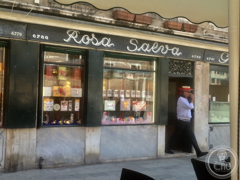 Exterior facade of historic Pasticceria Rosa Salva in Campo Santi Giovanni e Paolo with server in traditional straw hat Exterior facade of historic Pasticceria Rosa Salva in Campo Santi Giovanni e Paolo with server in traditional straw hat