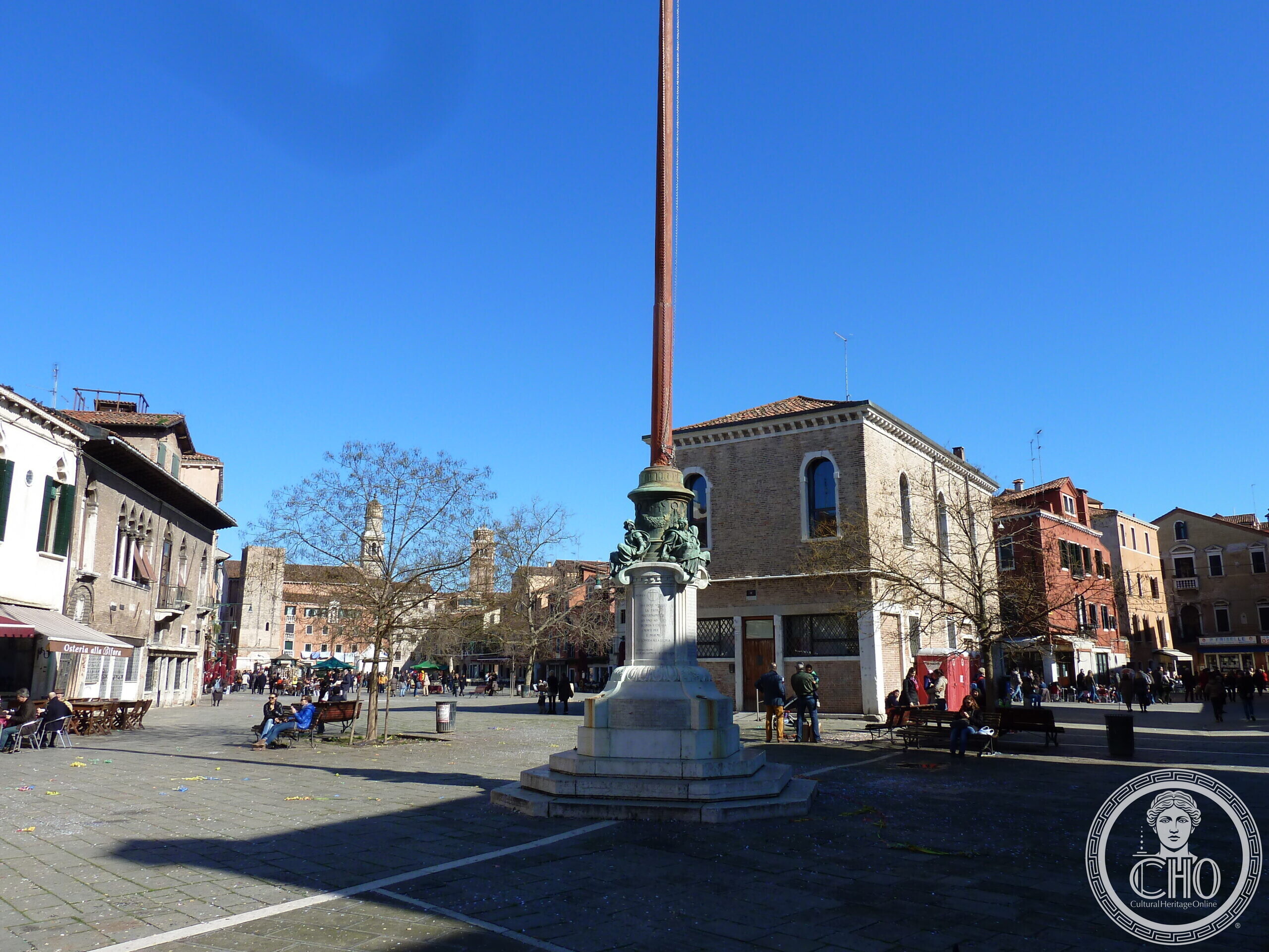 Flagpole war memorial in Campo Santa Margherita, Venice, with the Osteria alla Bifora in the background