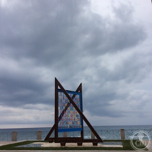 The number grid of the Pythagoras monument at Roccella Ionica, seen against the sky