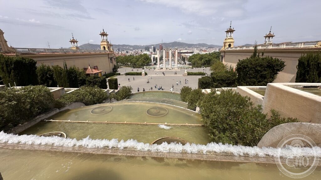 View down over the Font Màgica fountain terraces from the steps of the Palau Nacional toward Plaça d'Espanya and the Venetian Towers