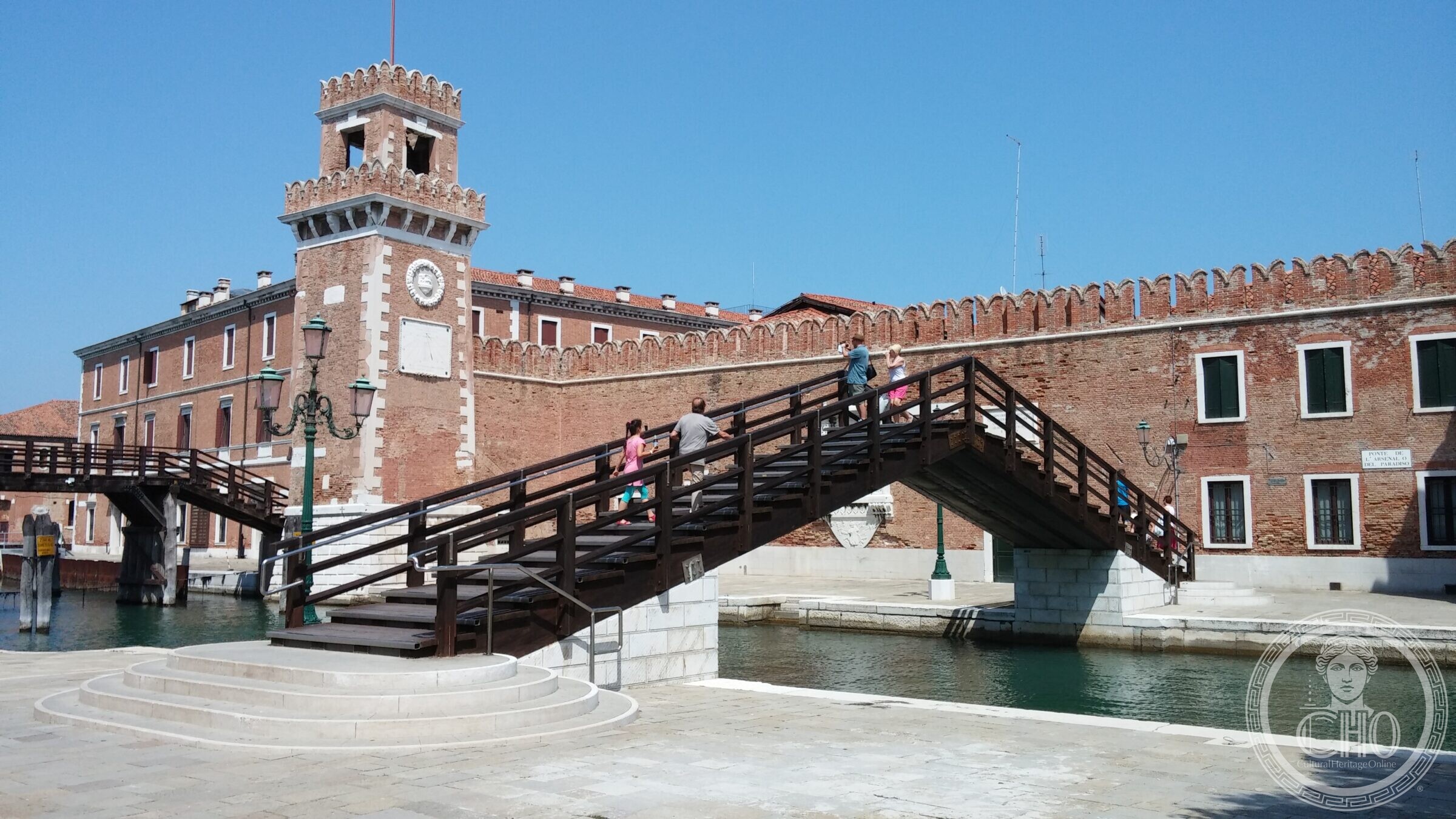 The Arsenal bridge from the other bank, with the clock tower and the crenellated Arsenal wall
