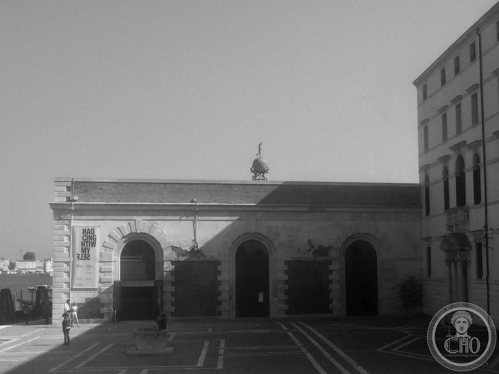 The low customs house at Punta della Dogana in Venice with the golden globe and Fortuna weathervane on its roof