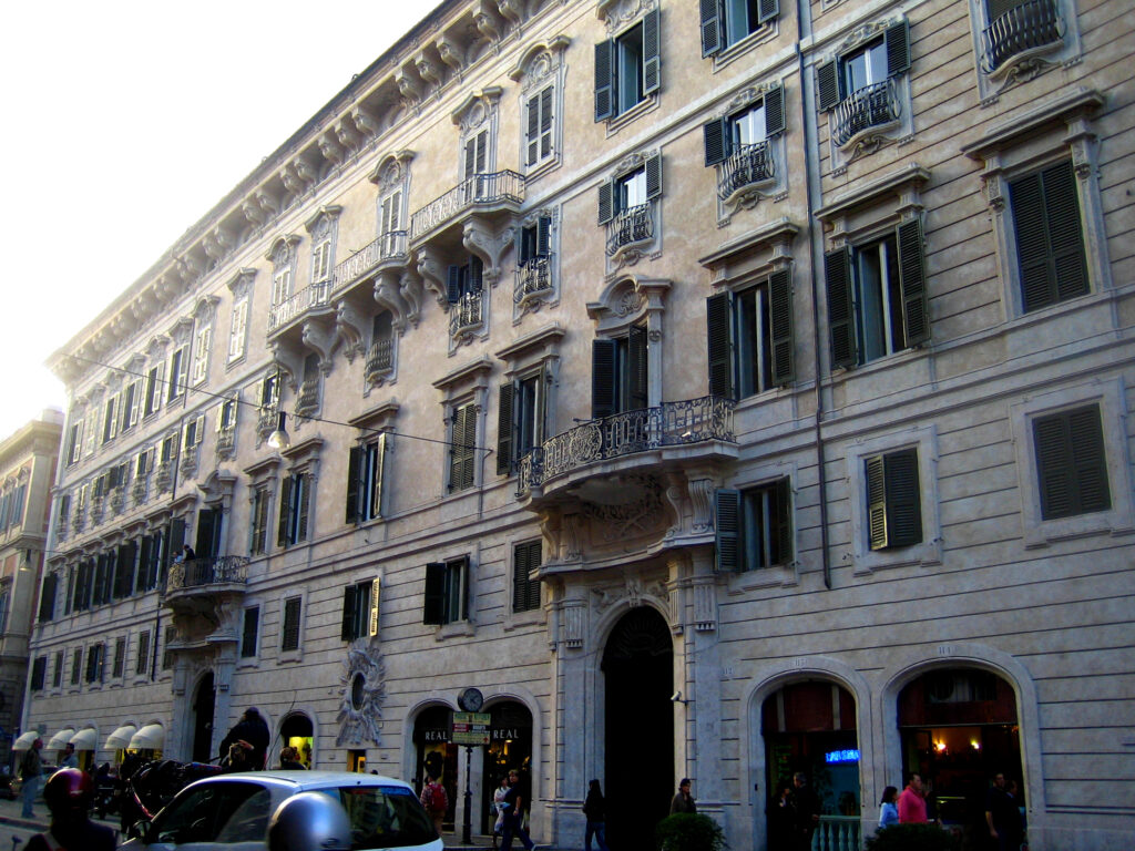 The monumental facade of Palazzo Doria Pamphilj along Via del Plebiscito in Rome