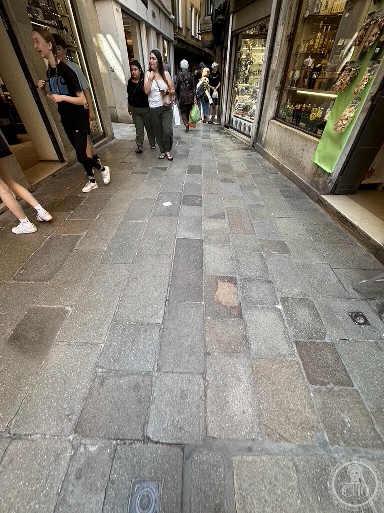 Street level perspective of Ruga Vecchia San Giovanni with traditional paving and artisanal shopfronts in Venice