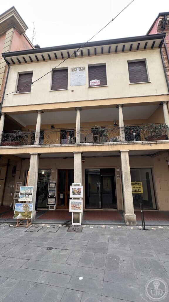 A house on via Molari in Santarcangelo di Romagna with a two-storey loggia on stone columns, the marble tablet set between the upper windows