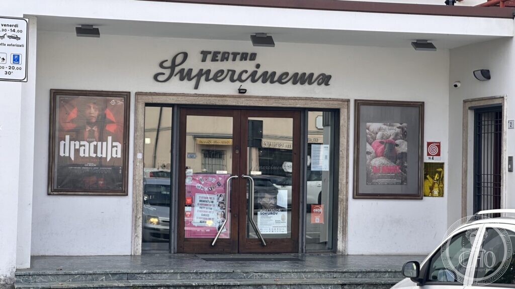 The entrance of the Teatro Supercinema at Santarcangelo di Romagna, with TEATRO in spaced capitals and Supercinema in a long sloping script in dark metal above the doors