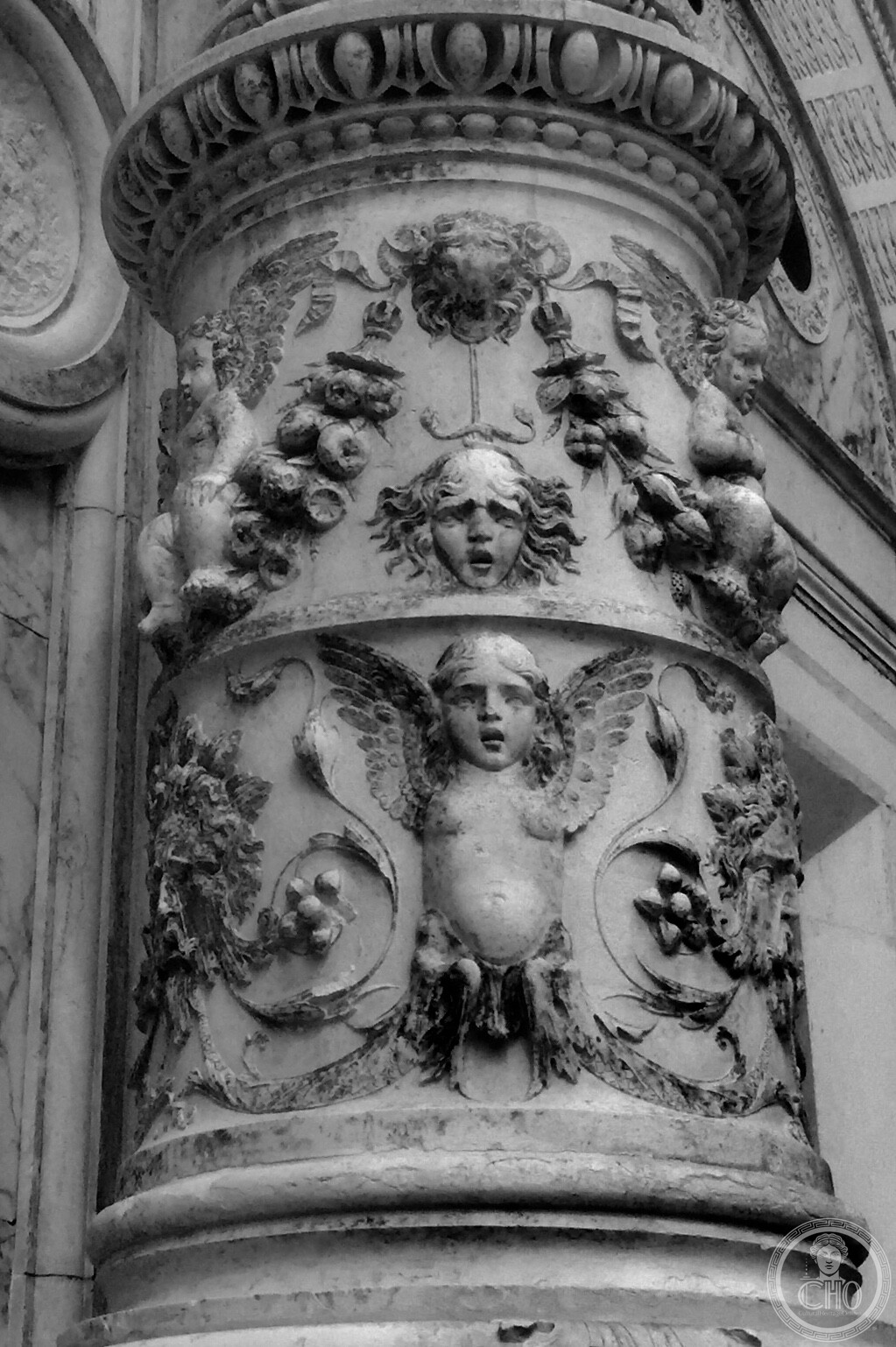 High-relief Renaissance carving of cherubs, swags and grotesque masks on portal column of Scuola Grande di San Marco