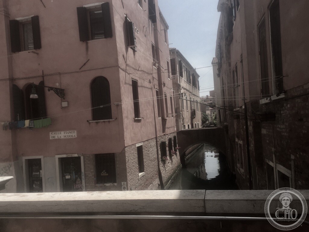 Looking from a bridge along the Rio de San Rocco, the flank of the Scuola on the right above the water