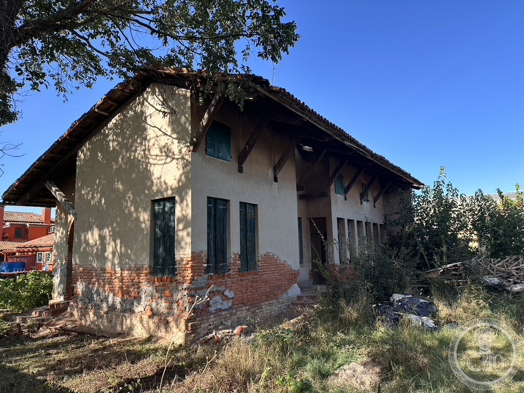 Covered loggia and side elevation of the former Scuola Vecchia on Torcello, in the Venetian Lagoon, before restoration