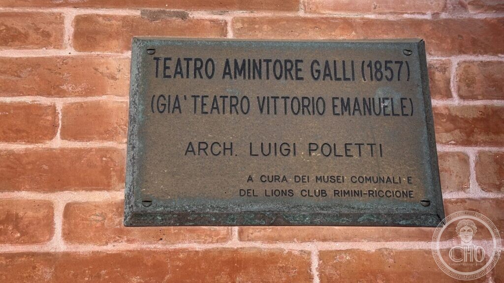 Bronze plaque reading Teatro Amintore Galli 1857, formerly Teatro Vittorio Emanuele, architect Luigi Poletti
