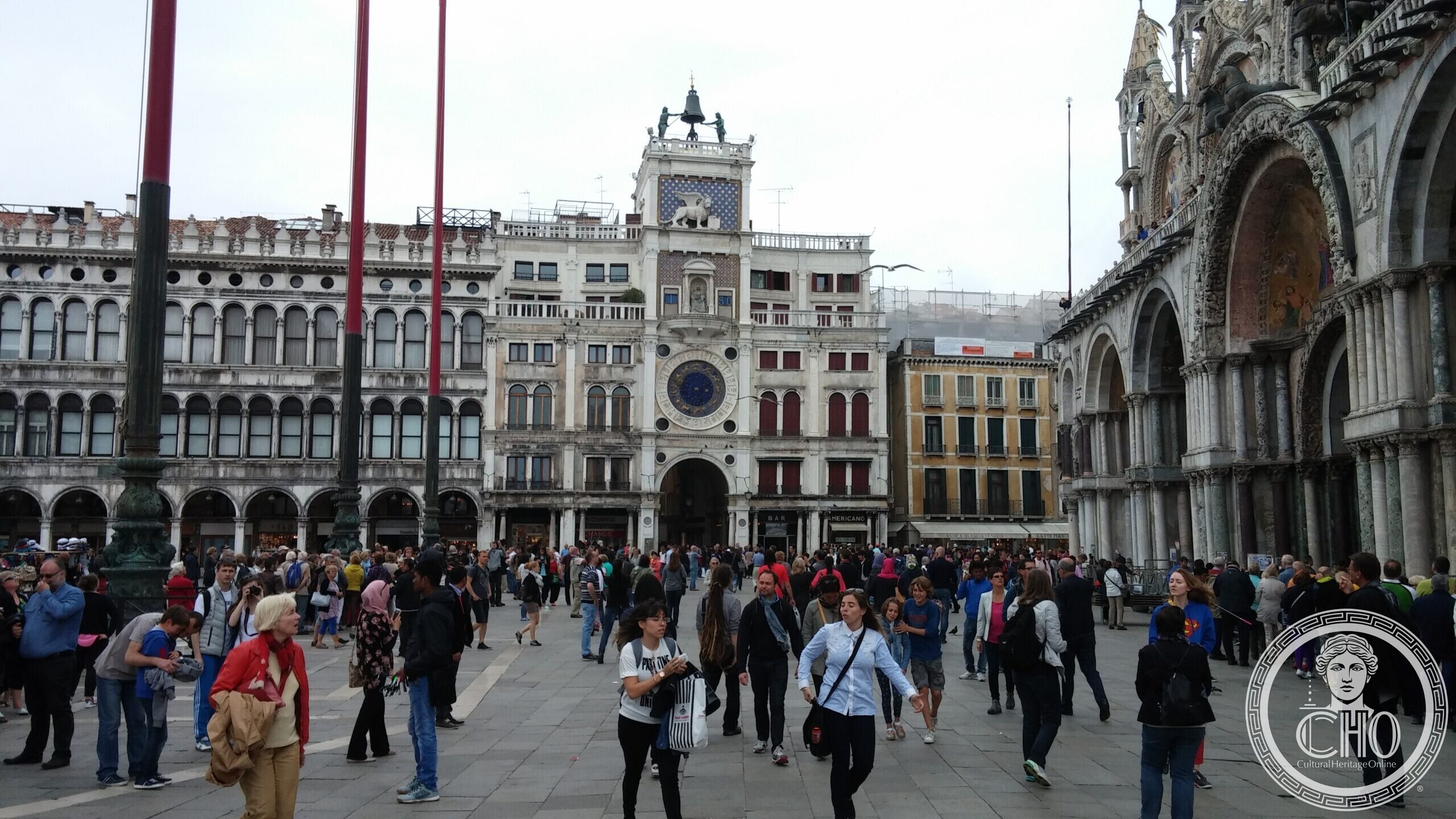 The Clock Tower of Piazza San Marco with its blue and gold dial, seen from the square