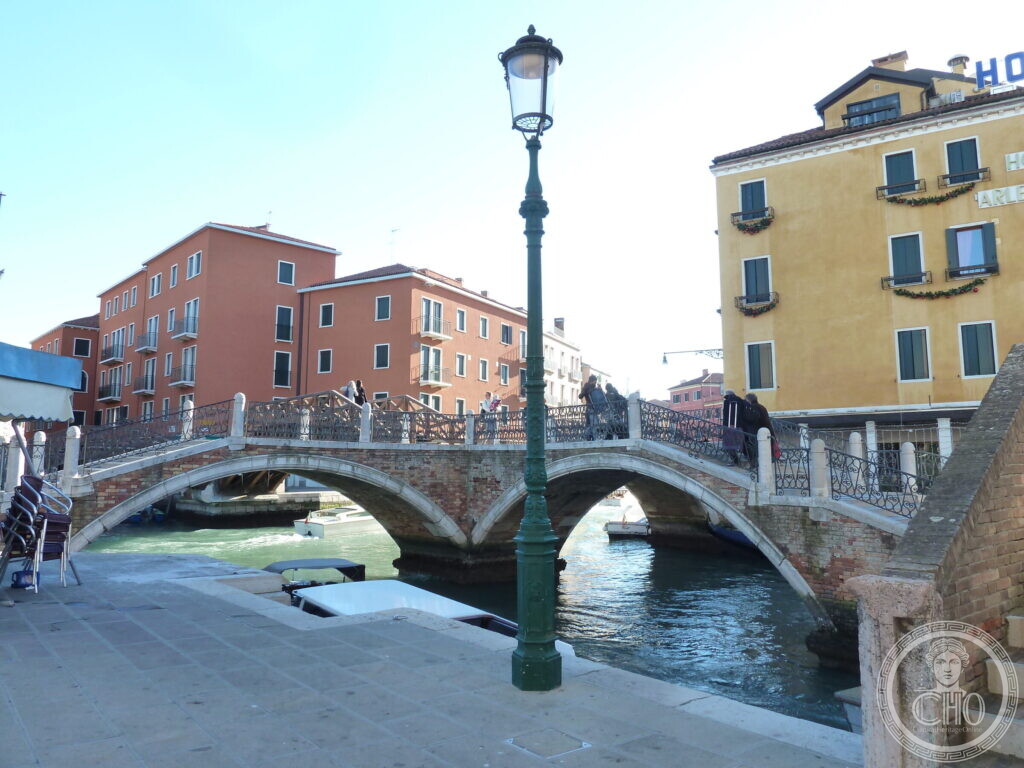 The Tre Ponti seen from the quayside with a cast-iron lamp standard in the foreground