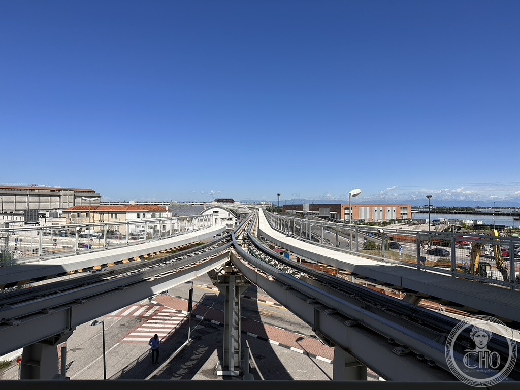 Elevated steel tracks of the modern Venice People Mover automated transit system connecting Tronchetto and Piazzale Roma under a clear sky